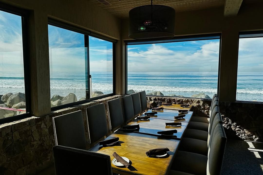The dining room at Pacific Coast Grill with windows over the Cardiff surf