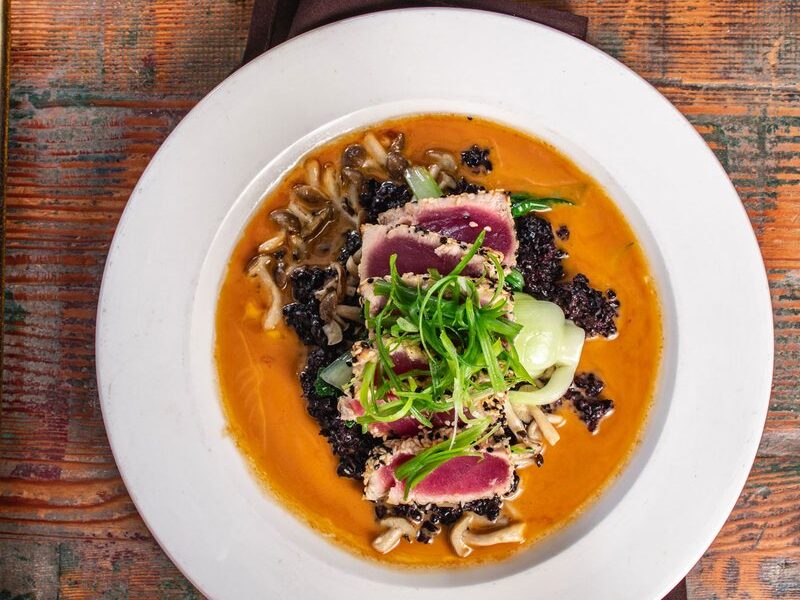 Sesame-crusted seared ahi over black forbidden rice with beech mushrooms and bok choy